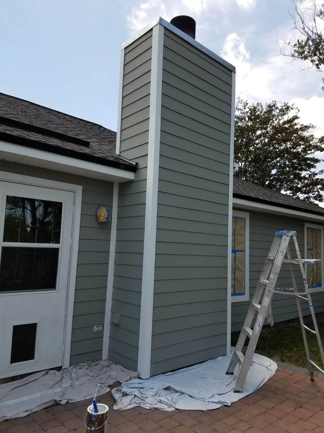 Painting siding on a chimney chase