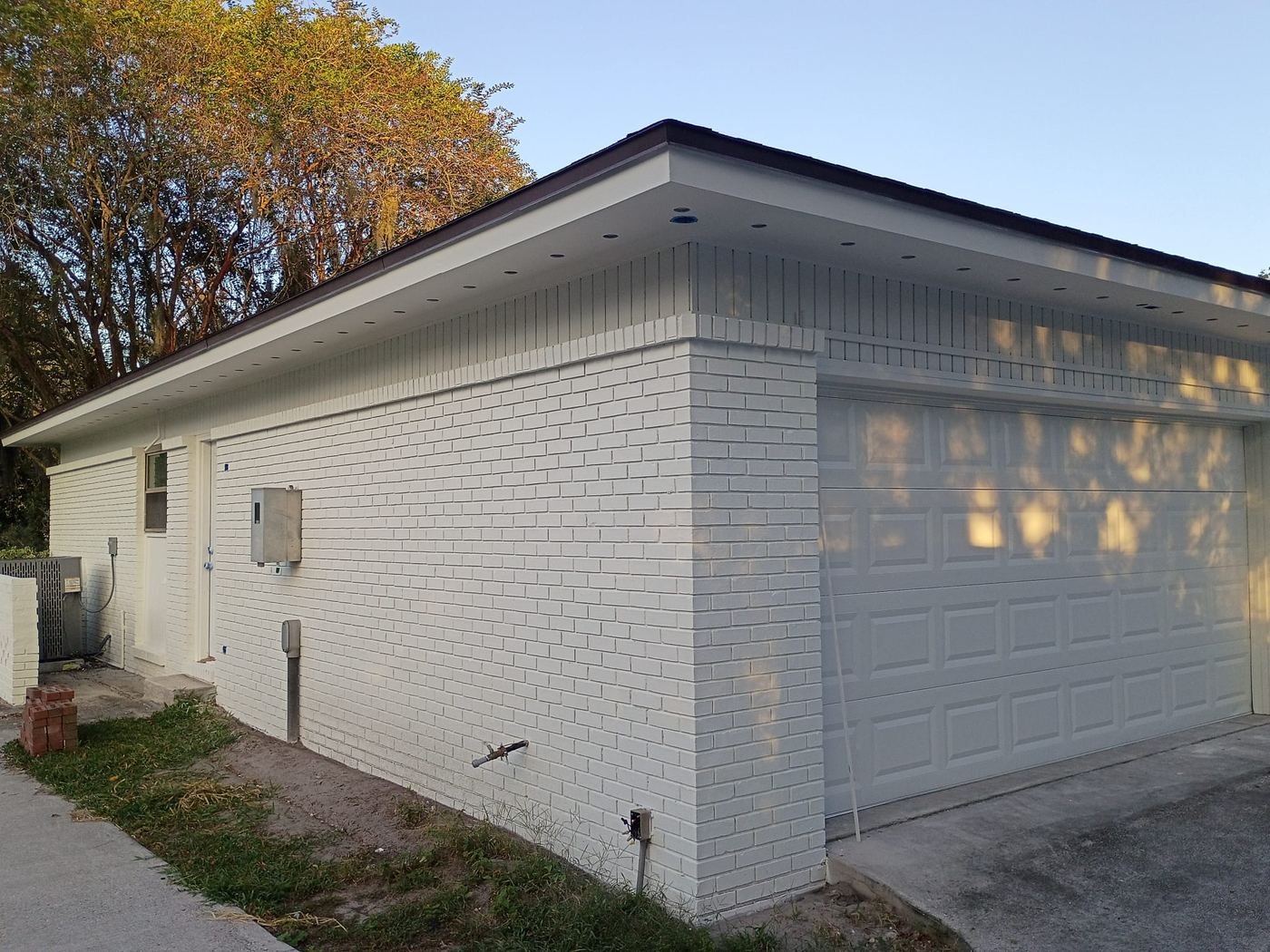 Side of a white-painted brick garage