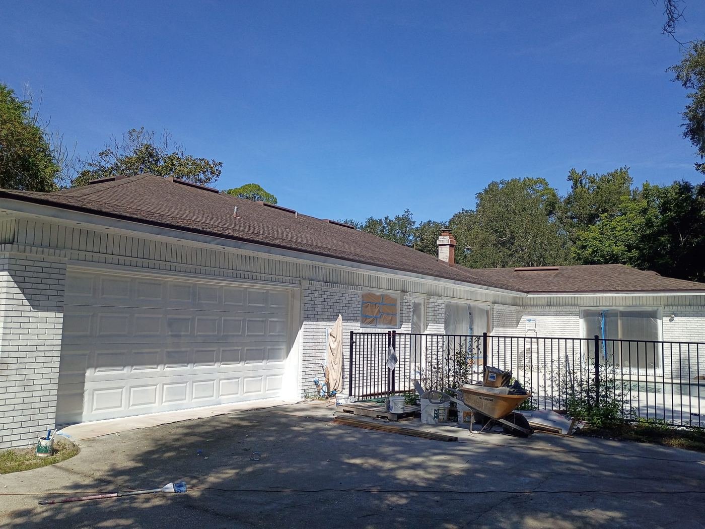 White brick exterior beside the pool fence