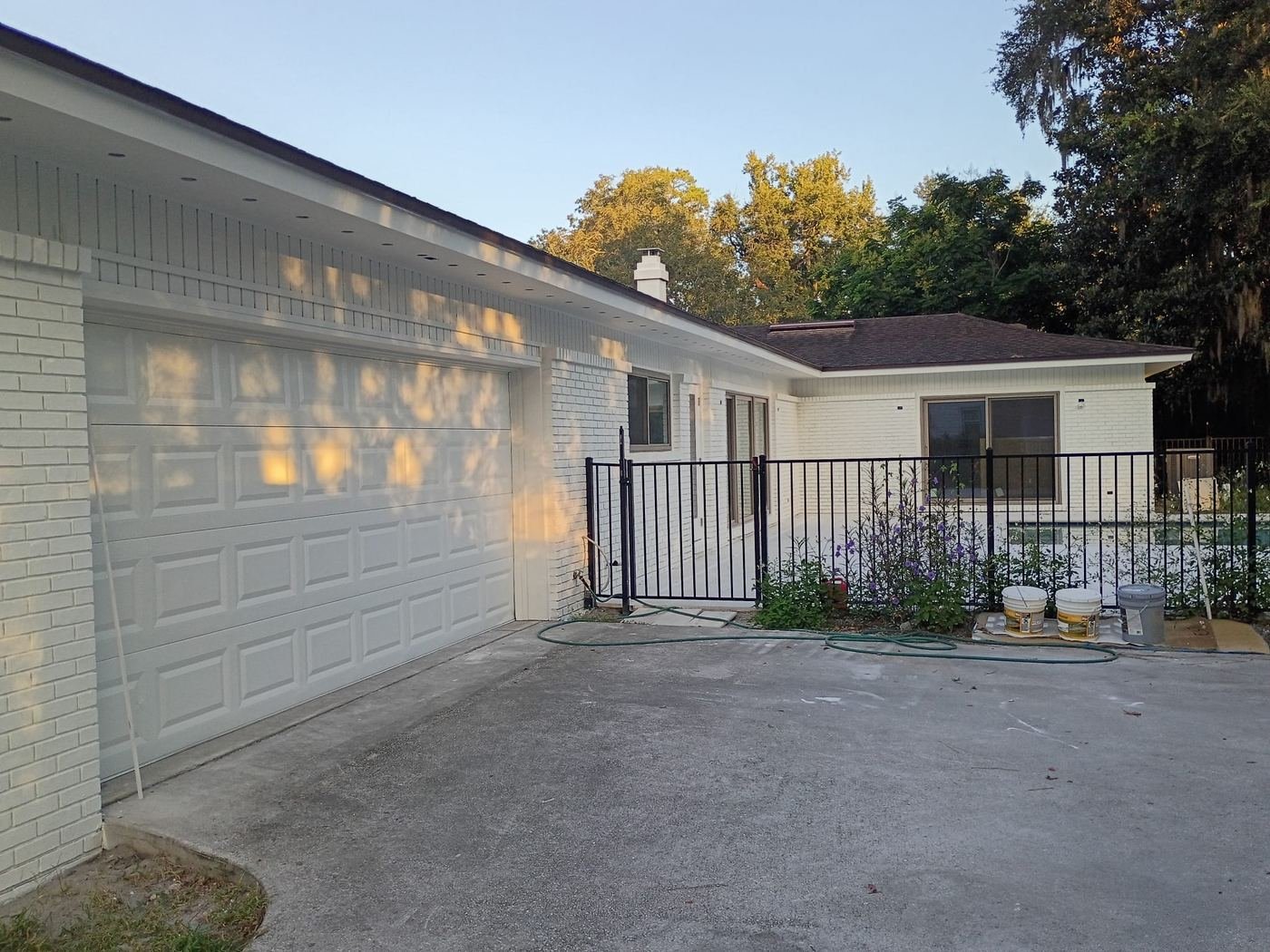 White-painted brick home and garage