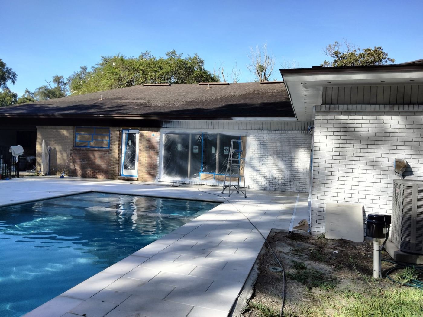 Brick pool house painted white