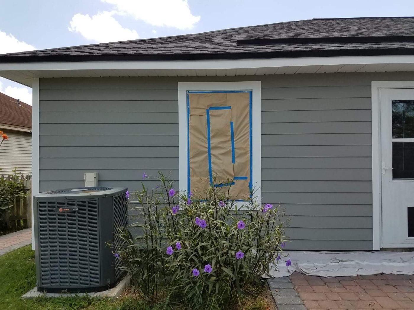 Window masked before painting the siding