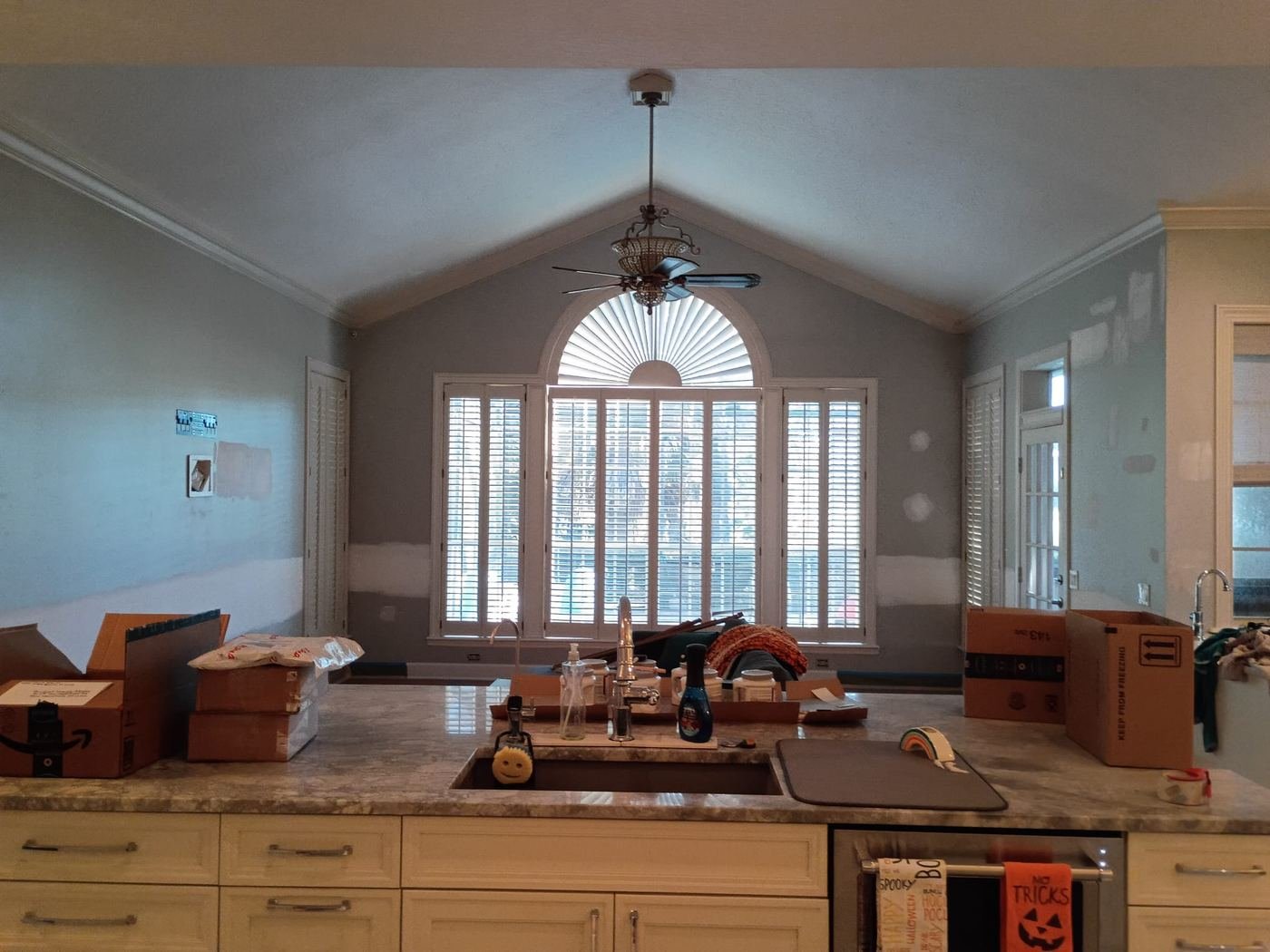 Kitchen with a vaulted ceiling in soft gray