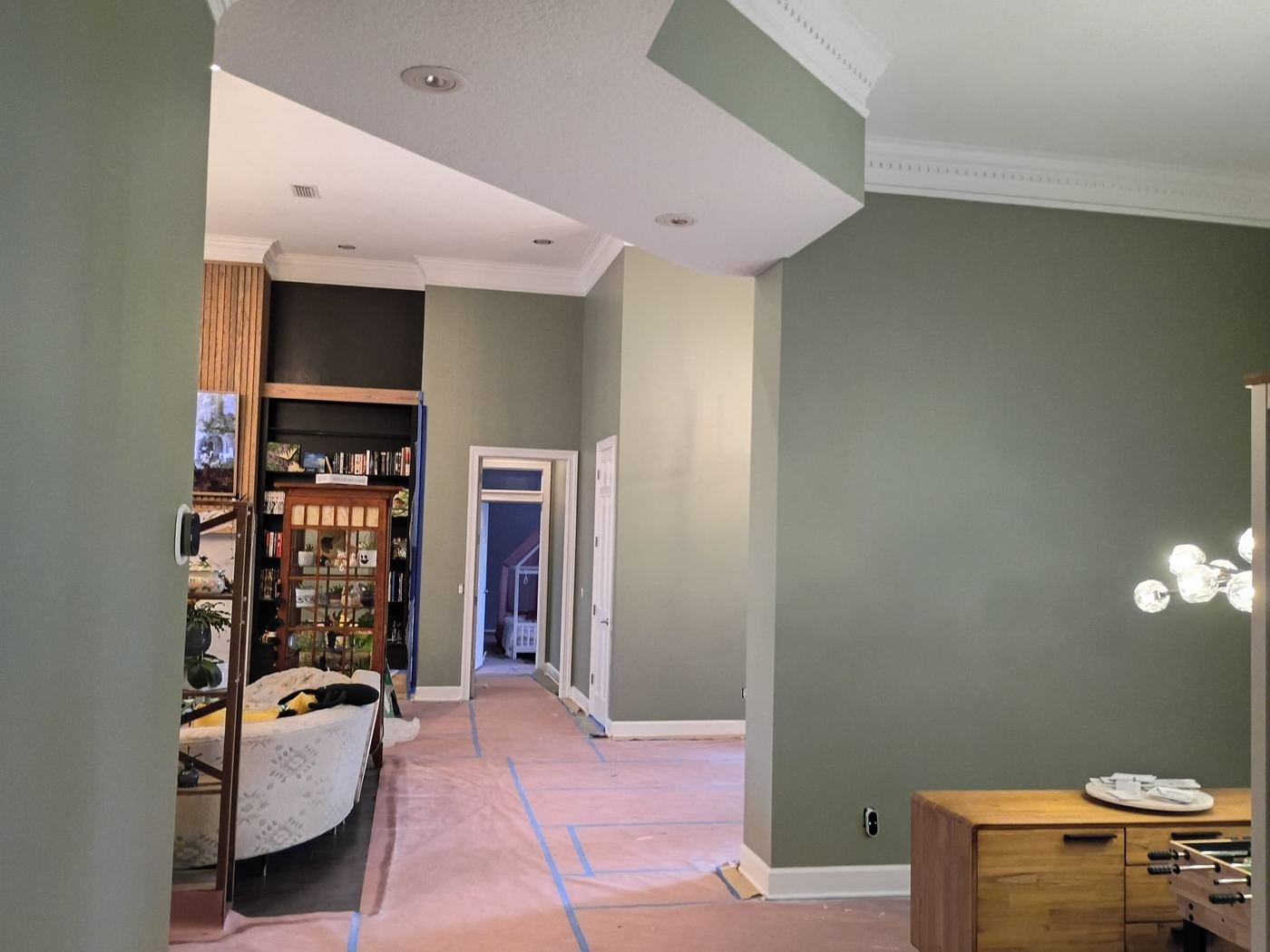 Living area painted in soft green, floors protected