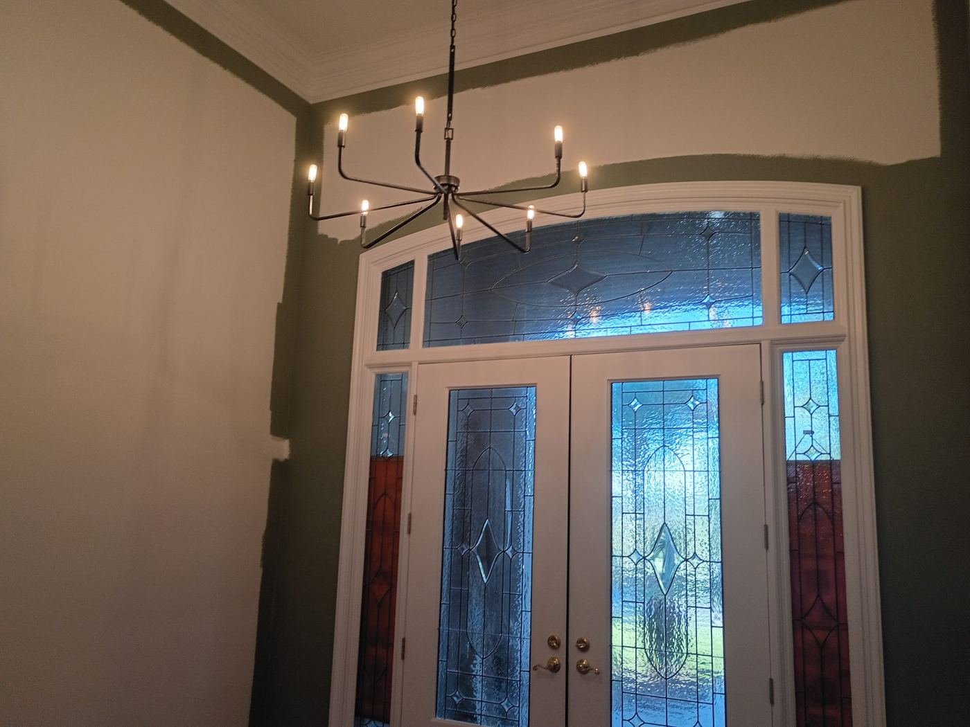 Foyer mid-repaint: new green going over the old color