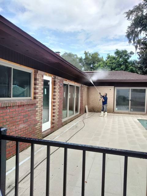 Pressure washing a pool deck and brick patio